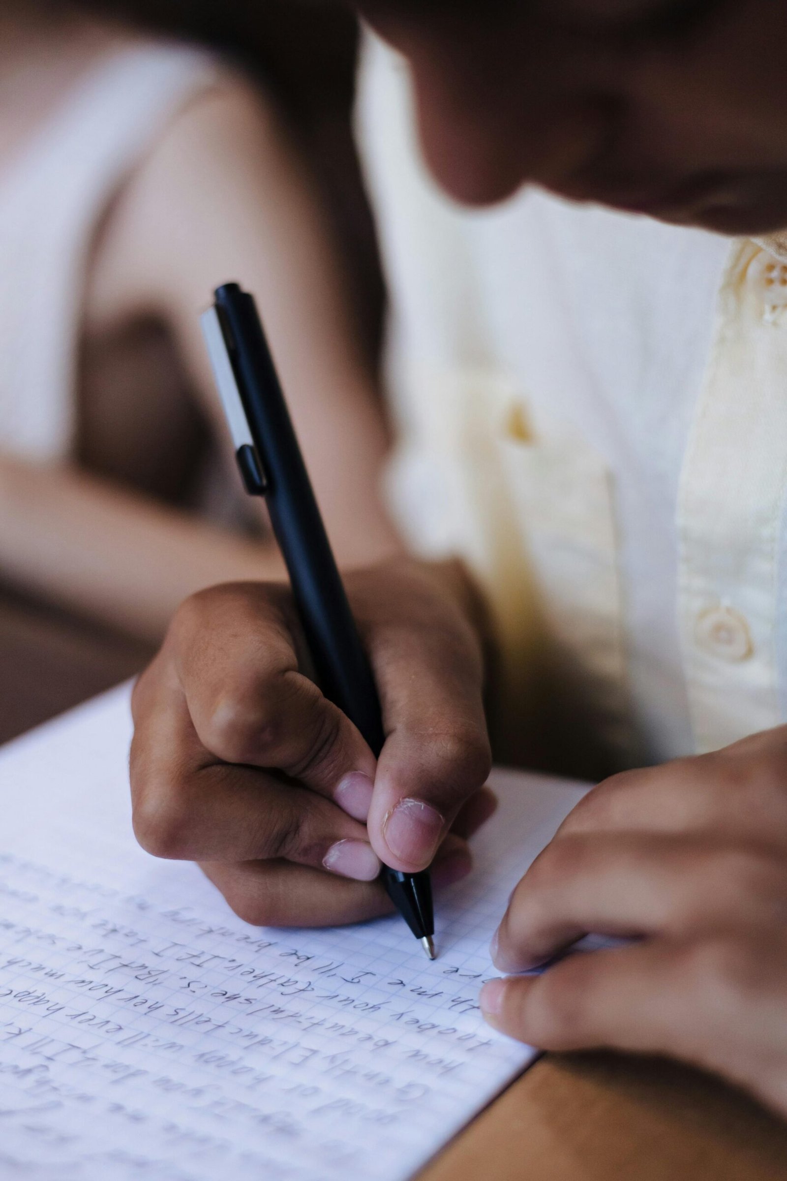 Student writing in a notebook